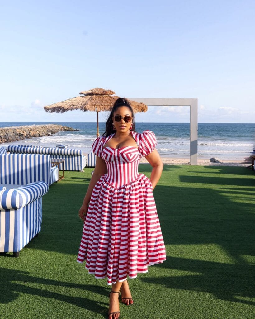 Erica Nlewedim Makes a Striped Milkmaid Dress the Ultimate Beach Holiday Statement